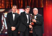 16 October 2009; Graham Canty, of Cork, is presented with his GAA Football All-Star award by Uachtarán CLG Criostóir Ó Cuana and Charles Butterworth, CEO Vodafone Ireland, during the 2009 GAA All-Stars Awards, sponsored by Vodafone. Citywest Hotel, Conference, Leisure & Golf Resort, Dublin. Picture credit: Brendan Moran / SPORTSFILE