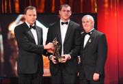 16 October 2009; Pearse O'Neill, of Cork, is presented with his GAA Football All-Star award by Uachtarán CLG Criostóir Ó Cuana and Charles Butterworth, CEO Vodafone Ireland, during the 2009 GAA All-Stars Awards, sponsored by Vodafone. Citywest Hotel, Conference, Leisure & Golf Resort, Dublin. Picture credit: Brendan Moran / SPORTSFILE