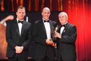 16 October 2009; Tadhg Kennelly, of Kerry, is presented with his GAA Football All-Star award by Uachtarán CLG Criostóir Ó Cuana and Charles Butterworth, CEO Vodafone Ireland, during the 2009 GAA All-Stars Awards, sponsored by Vodafone. Citywest Hotel, Conference, Leisure & Golf Resort, Dublin. Picture credit: Brendan Moran / SPORTSFILE