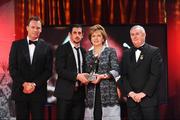 16 October 2009; Paul Galvin, of Kerry, is presented with his GAA Footballer of the Year All-Star award by President of Ireland Mary McAleese, Uachtarán CLG Criostóir Ó Cuana and Charles Butterworth, CEO Vodafone Ireland, during the 2009 GAA All-Stars Awards, sponsored by Vodafone. Citywest Hotel, Conference, Leisure & Golf Resort, Dublin. Picture credit: Brendan Moran / SPORTSFILE