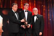 16 October 2009; Pearse O'Neill, of Cork, is presented with his GAA Football All-Star award by Uachtarán CLG Criostóir Ó Cuana and Charles Butterworth, CEO Vodafone Ireland, during the 2009 GAA All-Stars Awards, sponsored by Vodafone. Citywest Hotel, Conference, Leisure & Golf Resort, Dublin. Picture credit: Ray McManus / SPORTSFILE