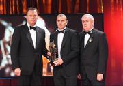 16 October 2009; John Miskella, of Cork, is presented with his GAA Football All-Star award by Uachtarán CLG Criostóir Ó Cuana and Charles Butterworth, CEO Vodafone Ireland, during the 2009 GAA All-Stars Awards, sponsored by Vodafone. Citywest Hotel, Conference, Leisure & Golf Resort, Dublin. Picture credit: Brendan Moran / SPORTSFILE