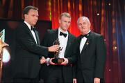 16 October 2009; Michael Shields, of Cork, is presented with his GAA Football All-Star award by Uachtarán CLG Criostóir Ó Cuana and Charles Butterworth, CEO Vodafone Ireland, during the 2009 GAA All-Stars Awards, sponsored by Vodafone. Citywest Hotel, Conference, Leisure & Golf Resort, Dublin. Picture credit: Ray McManus / SPORTSFILE