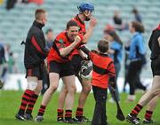 18 October 2009; Adare's Aidan O'Rahilly celebrates with a young supporter after the final whistle. Limerick County Senior Hurling Final, Adare v Na Piarsaigh, Gaelic Grounds, Limerick. Picture credit: Diarmuid Greene / SPORTSFILE