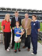 28 September 2009; 288 children from all over the country togged out today in the world-famous Croke Park stadium to attend the Vhi GAA Cúl Day Out. The 288 children were the lucky winners in the competition which was open to 82,500 children who attended a Vhi GAA Cúl Camp during the summer. Pictured after receiving his medal is Rachel Boyle, from Spiddal, Galway, with Vhi GAA Cúl Camps Ambassadors, from left, Cork ladies footballer Angela Walsh, former Meath footballer Colm O'Rourke, Dublin hurling manager Anthony Daly, and Wexford camogie player Mags D'Arcy. Croke Park, Dublin. Picture credit: Stephen McCarthy / SPORTSFILE