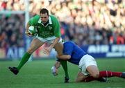 17 February 2001; Ireland's Girvan Dempsey is tackled by Richard Dourthe of France during the Lloyds TSB Six Nations Rugby Championship match between Ireland and France at Lansdowne Road in Dublin. Photo by Brendan Moran/Sportsfile