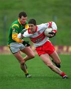 25 February 2001; Paul Carton of Derry in action against Richie Kealy of Meath during the Allianz National Football League Division 1B match between Meath and Derry at Páirc Tailteann in Navan, Meath. Photo by Damien Eagers/Sportsfile