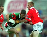 24 September 2000; Tony Geraghty of Mayo is tackled by Noel O'Donovan of Cork during the All Ireland Minor Football Championship Final match between Cork and Mayo at Croke Park in Dublin. Photo by Ray McManus/Sportsfile