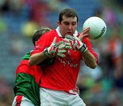 24 September 2000; Mark O'Connor of Cork is tackled by Paul Carey of Mayo during the All Ireland Minor Football Championship Final match between Cork and Mayo at Croke Park in Dublin. Photo by Ray Lohan/Sportsfile