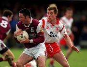 25 February 2001; Kieran Comer of Galway is tackled by Eoin Gormley of Tyrone during the Allianz National Football League Division 1A match between Galway and Tyrone at Duggan Park in Ballinasloe, Galway. Photo by Ray McManus/Sportsfile