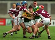 25 February 2001; Liam Redmond of Dunloy is tackled by Brian Hanley, 9, and John Feeney, 4, of Athenry during the AIB All-Ireland Senior Club Hurling Championship Semi-Final match between Athenry and Dunloy at Parnell Park in Dublin. Photo by Ray Lohan/Sportsfile