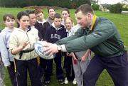 15 January 2001; David Corkery demonstrating a pass to pupils during a visit to Rushbrooke Convent of Mercy National School in Cobh, Cork. Photo by Sportsfile