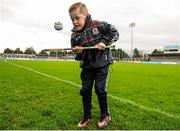 24 January 2016; Galway supporter Fionn Kelly, age 6, from Co. Kildare, practices his hurling skills before the start of the match. Bord na Mona Walsh Cup, Semi-Final, Dublin v Galway, Parnell Park, Dublin. Picture credit: Seb Daly / SPORTSFILE
