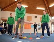 26 January 2016; Minister for Health Leo Varadkar, centre, is coached through the hockey skills challenge by Hockey Ireland players Megan Frazer, left, and Nicci Daly, right, at a Hockey Ireland - Hockey Skills Challenge Blakestown. Scoil Mhuire, Blakestown, Dublin. Picture credit: Seb Daly / SPORTSFILE
