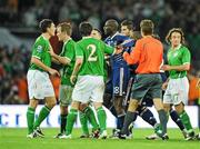 14 November 2009; Keith Andrews, Republic of Ireland, and Alou Diarra, France square up after the final whistle. FIFA 2010 World Cup Qualifying Play-off 1st Leg, Republic of Ireland v France, Croke Park, Dublin. Picture credit: Matt Browne / SPORTSFILE