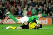 14 November 2009; Robbie Keane, Republic of Ireland, lands on Hugo Lloris, France. FIFA 2010 World Cup Qualifying Play-off 1st Leg, Republic of Ireland v France, Croke Park, Dublin. Photo by Sportsfile