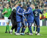14 November 2009; Richard Dunne, right, Republic of Ireland, with French players at the end of the game. FIFA 2010 World Cup Qualifying Play-off 1st Leg, Republic of Ireland v France, Croke Park, Dublin. Picture credit: David Maher / SPORTSFILE
