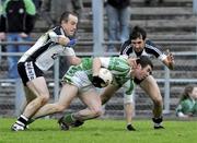 15 November 2009; Paul Young, Loup, in action against Sean O'Hanlon, left, and Aidan Branigan, St. Patrick's, Kilcoo. AIB GAA Football Ulster Senior Club Championship Semi-Final, Loup v St. Patrick's, Kilcoo, Casement Park, Belfast. Picture credit: Michael Cullen / SPORTSFILE