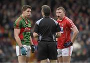 31 January 2016; Referee Maurice Deegan speaks to Lee Keegan, Mayo, and Brian Hurley, Cork, before showing each a yellow card. Allianz Football League, Division 1, Round 1, Cork v Mayo. Páirc Ui Rinn, Cork. Picture credit: Diarmuid Greene / SPORTSFILE