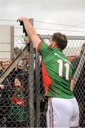 31 January 2016; Aidan O'Shea, Mayo, passes his gloves over the fence to a young Mayo supporter. Allianz Football League, Division 1, Round 1, Cork v Mayo, Páirc Ui Rinn, Cork. Picture credit: Eoin Noonan/SPORTSFILE