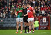 31 January 2016; Mayo captain Lee Keegan and Cork captain Paul Kerrigan exchange a handshake in the company of referee Maurice Deegan before the pre-match coin toss. Allianz Football League, Division 1, Round 1, Cork v Mayo. Páirc Ui Rinn, Cork. Picture credit: Diarmuid Greene / SPORTSFILE