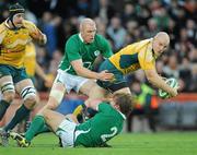 15 November 2009; Stephen Moore, Australia, is tackled by Jerry Flannery, 2, and Paul O'Connell, Ireland. Autumn International Guinness Series 2009, Ireland v Australia, Croke Park, Dublin. Picture credit: Brendan Moran / SPORTSFILE