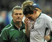 18 November 2009; The Republic of Ireland team doctor, Dr Alan Byrne, with a dejected Keith Andrews after the game. FIFA 2010 World Cup Qualifying Play-off 2nd Leg, Republic of Ireland v France, Stade de France, Saint-Denis, Paris, France. Picture credit: David Maher / SPORTSFILE