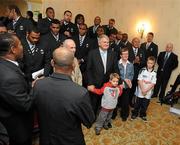 20 November 2009; The Fijian rugby team welcomed Mr Denis O’Brien, Founder of Digicel, the Fijian rugby team sponsor, to the official team blessing. The Fijian ritual, which took place at the Radisson Hotel, Stillorgan, involves the blessing of the team jerseys before each game. The team then presented Mr O’Brien with a signed jersey ahead of their clash with Ireland. Pictured are Mr Denis O’Brien, Founder of Digicel, and his sons Patrick, age 5, and Jack, age 10, with the Fiji players and officials. Radisson Blu St Helens Hotel, Stillorgan Road, Dublin. Picture credit: Brian Lawless / SPORTSFILE