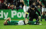 21 November 2009; Ireland's Denis Leamy lies on the ground with a suspected leg injury as he is attended to by Irish team doctor, Dr Eanna Falvey. Autumn International Guinness Series 2009, Ireland v Fiji, Royal Dublin Society, Ballsbridge, Dublin. Picture credit: Brendan Moran / SPORTSFILE