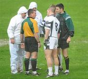 22 November 2009; Clara captain Scott Brady, 8, approaches match referee Joe Curley as he consults with his umpires and stand-by referee Gary McCormack, right, before starting the second-half. Five minutes into the second-half he abandoned the game. Portlaoise v Clara - AIB GAA Football Leinster Club Senior Championship Semi-Final, O'Moore Park, Portlaoise. Picture credit: Ray McManus / SPORTSFILE