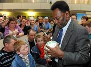 26 November 2009; Pelé signs a football for Christopher O'Brien, age 7, from Bray, Co. Wicklow, during a visit to Our Lady's Children's Hospital, Crumlin, Dublin. Picture credit: Pat Murphy / SPORTSFILE