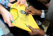 26 November 2009; Pelé signs a shirt for fans during a visit to Our Lady's Children's Hospital, Crumlin, Dublin. Picture credit: Pat Murphy / SPORTSFILE