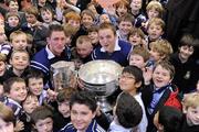 30 November 2009; All-Ireland winning captains and Ulster Bank employees Michael Fennelly, Kilkenny, and Darran O’Sullivan, Kerry, are pictured with delighted school children from Terenure College. The Ulster Bank pair are visiting schools to celebrate their fantastic achievement and promote GAA with primary and secondary school children. Terenure College, Terenure, Dublin. Picture credit: Pat Murphy / SPORTSFILE
