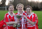 29 November 2009; Donamoyne players, from left, Hazel Kingham, Michelle Grimes and Lisa Kingham celebrate with the Dolores Tyrrell Memorial cup. Tesco All-Ireland Ladies Senior Club Championship Final, Donoughmore, Cork v Donamoyne, Monaghan, St. Rynagh's GAA Club, Banagher, Co. Offaly. Picture credit: Ray McManus / SPORTSFILE