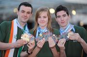 2 December 2009; Members of the Ireland Taekwon-Do team, from left, Luke Woods, Dublin, Louise McCagh, Shannon, Co. Clare, and Dylan Fitzgibbon, from Cork City, with the medals they won at the Taekwon-Do World Championships in Argentina, on the Irish team's arrival in Dublin Airport. The 36 strong team won a total of 11 medals, 2 Gold, 3 Silver and 6 Bronze. Dublin Airport, Dublin. Picture credit: Brendan Moran / SPORTSFILE