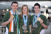 2 December 2009; Members of the Ireland Taekwon-Do team, from left, Luke Woods, Dublin, Louise McCagh, Shannon, Co. Clare, and Dylan Fitzgibbon, from Cork City, with the medals they won at the Taekwon-Do World Championships in Argentina, on the Irish team's arrival in Dublin Airport. The 36 strong team won a total of 11 medals, 2 Gold, 3 Silver and 6 Bronze. Dublin Airport, Dublin. Picture credit: Brendan Moran / SPORTSFILE
