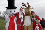 5 December 2009; The McLoughlin Family from Dundalk Co. Louth, Martin, Gheni and their three year old son Jack, with Christmas mascots, Mr. Snowman and Mr. Reindeer, at the finish of the 19th Annual Jingle Bells 5K Race, The Phoenix Park, Dublin. Picture credit: Tomas Greally / SPORTSFILE