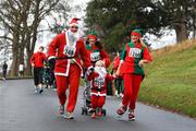 5 December 2009; From left, Martin McLaughlin with his sister Jane, three year old son Jack and wife Gheni, from Dundalk, Co. Louth, in action during the 19th Annual Jingle Bells 5K Race, The Phoenix Park, Dublin. Picture credit: Tomas Greally / SPORTSFILE