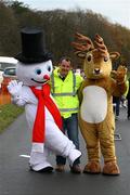 5 December 2009; Race director, Dave Hudson, Donore Harriers A.C., with Christmas mascots, Mr. Snowman and Mr. Reindeer, at the finish of the 19th Annual Jingle Bells 5K Race, The Phoenix Park, Dublin. Picture credit: Tomas Greally / SPORTSFILE