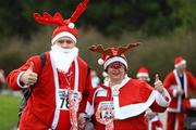 5 December 2009; Joseph Nagle, from Islandbridge, Dublin, and Sarah Webb, from Stoneybatter, Dublin, in action during the 19th Annual Jingle Bells 5K Race, The Phoenix Park, Dublin. Picture credit: Tomas Greally / SPORTSFILE