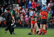 6 December 2009; Charlotte-Marie Raher, St Anne's Dunhill, gives some assistance to Mary O'Kane, Lavey, in the dying moments of extra-time. All-Ireland Junior Camogie Club Championship Final, Lavey, Derry v St Anne's Dunhill, Waterford, Donaghmore Ashbourne, Co. Meath. Picture credit: Brian Lawless / SPORTSFILE