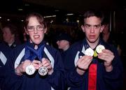 13 March 2001; Lorraine Whelan from Delganey in Wicklow shows off her two silver medals while Warren Tate from Blackrock, Dublin shows his gold and silver, when Ireland's Special Olympics Team from the 2001 Special Olympics World Winter Games in the Alyeska resort in Girdwood, Alaska, USA arrived home at Dublin Airport. Photo by Gerry Barton/Sportsfile