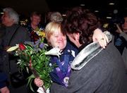 13 March 2001; Jacinta O'Neill from Glasnevin in Dublin who brought home a silver medal is greeted by a well wisher, when Ireland's Special Olympics Team from the 2001 Special Olympics World Winter Games in the Alyeska resort in Girdwood, Alaska, USA arrived home at Dublin Airport. Photo by Gerry Barton/Sportsfile