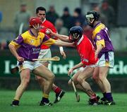 1 April 2001; Pat Mulcahy of Cork, supported by team-mate Seán Óg Ó hAilpín, behind, in action against Sean Flood, left and Darren Stamp of Wexford during the Allianz GAA National Hurling League Division 1B Round 4 match between Wexford and Cork at at Bellefield in Enniscorthy, Wexford. Photo by Aoife Rice/Sportsfile