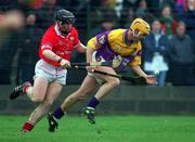1 April 2001; Rory McCarthy of Wexford in action against Wayne Sherlock of Cork during the Allianz GAA National Hurling League Division 1B Round 4 match between Wexford and Cork at at Bellefield in Enniscorthy, Wexford. Photo by Aoife Rice/Sportsfile