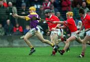 1 April 2001; Michael Jordan of Wexford races clear of Wayne Sherlock and Joe Deane, right, of Cork during the Allianz GAA National Hurling League Division 1B Round 4 match between Wexford and Cork at at Bellefield in Enniscorthy, Wexford. Photo by Aoife Rice/Sportsfile