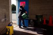 31 March 2001; &quot;Kinger&quot; Pat King, a member of the ground staff at Semple Stadium, sprays disinfectant on to a matt at an entrance in an effort to stop the spread of Foot and Mouth Disease before the AIB All-Ireland Senior Club Hurling Championship Semi-Final Replay match between Graigue Ballycallan and Sixmilebridge at Semple Stadium in Thurles, Tipperary. Photo by Ray McManus/Sportsfile