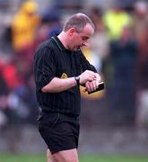 1 April 2001; Referee John Sexton checks his watch during the Allianz GAA National Hurling League Division 1B Round 4 match between Wexford and Cork at at Bellefield in Enniscorthy, Wexford. Photo by Aoife Rice/Sportsfile