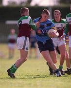 4 April 2001; Nigel Crawford of UCD is tackled by Ciaran Meenagh of St Mary's during the Sigerson Cup match between UCD and St Mary's at Walterstown GFC in Navan, Meath. Photo by Aoife Rice/Sportsfile