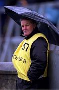 8 April 2001; A Dublin official shelters from the rain during the Allianz GAA National Football League Division 1A match between Dublin and Galway at Parnell Park in Dublin. Photo by Ray McManus/Sportsfile